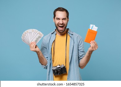 Joyful Traveler Tourist Man In Summer Clothes With Photo Camera Isolated On Blue Background. Passenger Traveling On Weekends. Air Flight Journey. Hold Passport Boarding Pass Ticket Fan Of Cash Money