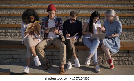 Joyful university students study together after classes. - Shutterstock ID 1737154385