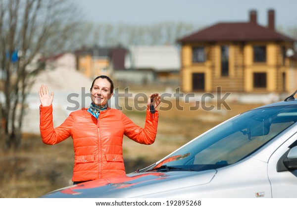 joyful woman with \
keys in hands  car at\
home