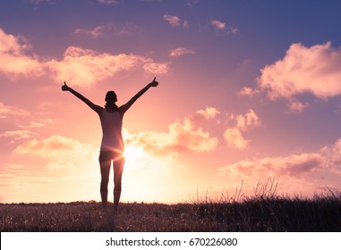 Joyful woman outdoors with her hands in the sky.  - Shutterstock ID 670226080