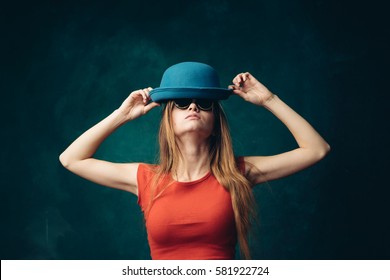 Joyful woman wears a hat, a bright background