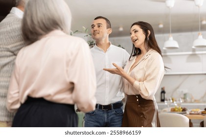 Joyful young adult woman introducing boyfriend to elderly parents in cozy home setting. Concept of family acceptance and intergenerational relationships.. - Powered by Shutterstock