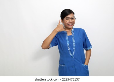 Joyful Young Asian Woman Standing While Showing Telephone Hand Gesture. Isolated On White Background