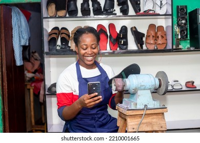 Joyful young  Excited african woman businesswoman using  mobile phone at her shop  - Powered by Shutterstock