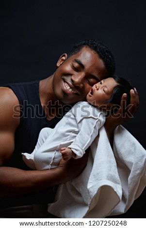 joyful young father with his favourite child. unforgettable moments. happu daddy spending time with his infant. isolated black background.unique conncecccion