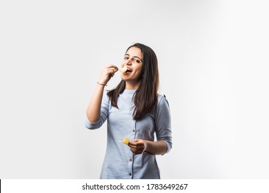 Joyful Young Indian Woman Eating Potato Chips Isolated On White Background