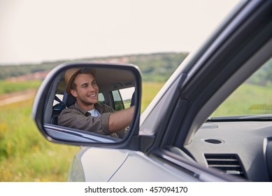 Joyful young man driving transport