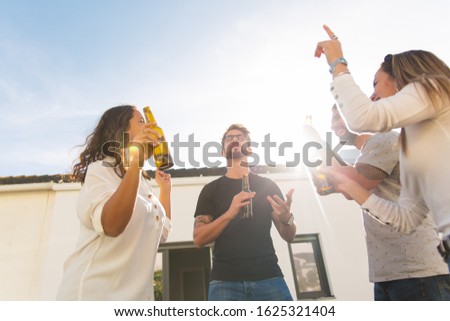 Similar – Multiethnic friends resting outside food truck in evening