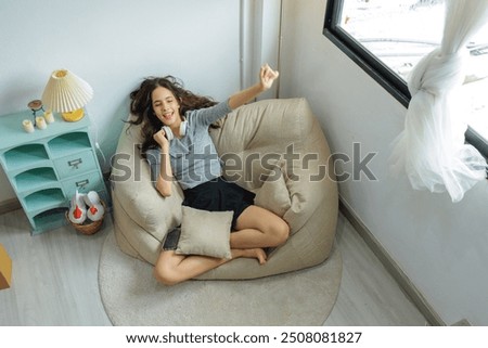 Similar – Woman in an armchair