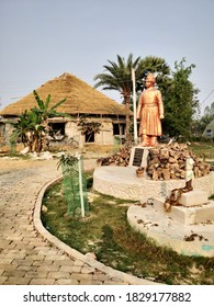 JOYGOPALPUR, INDIA - OCTOBER 6, 2020: A small statue of Swami Vivekananda with a village hut next to it at a village in Joygopalpur, India- 9th Feb 2018