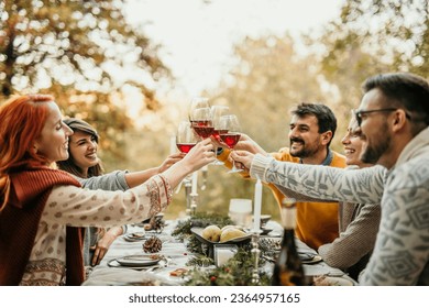 The joyous ambiance of a garden party, with a diverse group of people relishing a shared meal amidst nature's beauty. - Powered by Shutterstock