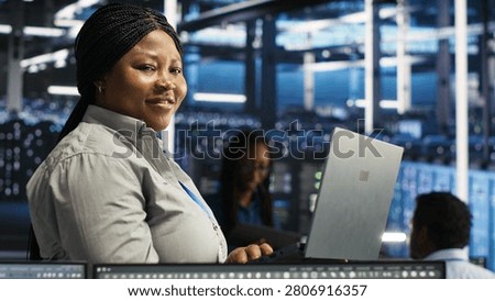 Joyous data center technician working with AI visualization insights to improve system health.