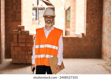 Joyous foreman posing for camera during building site inspection