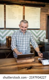 Joyous Mature Man Working In A Coffee Shop