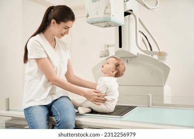 Joyous mother and little child before pediatric digital radiography - Powered by Shutterstock