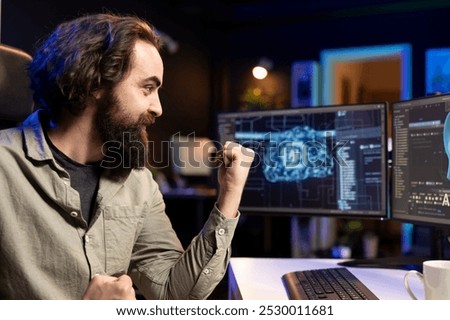 Joyous software developer celebrating after awakening sentient AI capable of human level of intelligence. IT professional delighted to interact with self aware sentient artificial intelligence