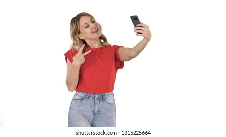 Joyous woman 30s wearing red t-shirt taking selfie photo while walking/ on white background. - Powered by Shutterstock