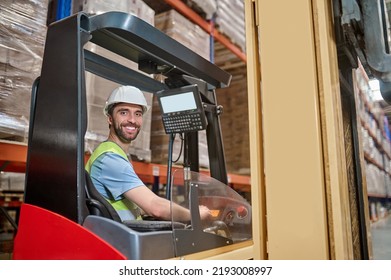 Joyous young lift truck operator at work - Shutterstock ID 2193008997