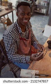 Joyous Young Male Potter Working With Clay