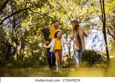  The joys of family life. Parents spending time with their children outside. Focus is on foreground. - Powered by Shutterstock