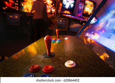 Joystick And Button Controls Of A Vintage Arcade Video Game In A Dark Room With Dark Blue And Yellow Lights
