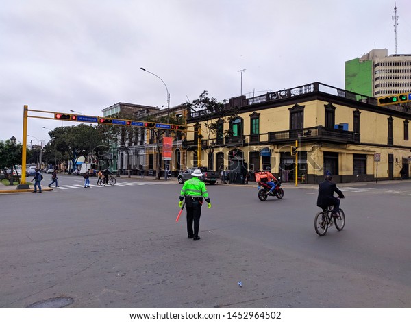 jpg, Lima, Lima, Peru, july 15th\
2019 \
traffic police signaling traffic in the avenida\
Colon