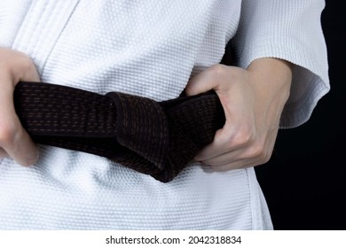 Ju Jitsu fighter. Womans holding a Brown belt wearing a Kimono. Martial arts  fighter