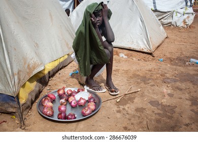 Juba, South Sudan - April 10, 2014: A South Sudanese Child Sells Onions In A Refugee Camp