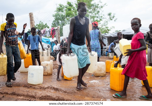 Juba, South Sudan - April 10, 2014: South\
Sudanese children get the daily ration of\
water