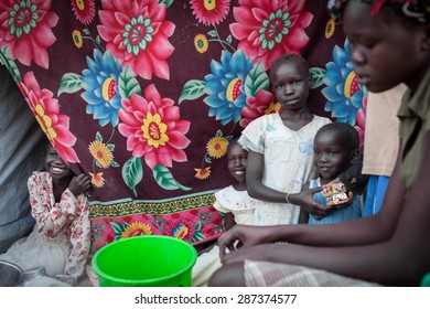 Juba, South Sudan - February 19, 2014: South Sudanese Children Watch Their Mother Cook In A Refugee Camp