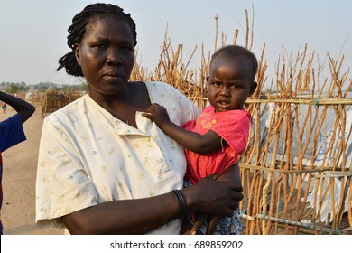 Juba, South Sudan, February 2017. Salesian Camp For Internally Displaced Persons (IDPs). Portrait Of A Woman Holding Her Baby. Captured During Civil War.