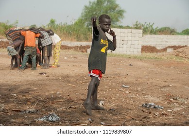 JUBA, SOUTH SUDAN - FEBRUARY 26 2012: Unidentified Kids Play On A Street Of Juba, South Sudan. Juba Is Full Of Refugees And Their Children Have To Fend For Themselves.