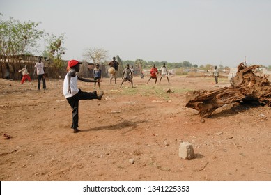 JUBA, SOUTH SUDAN - FEBRUARY 26 2012: Unidentified kids from displaced persons camp play on street of Juba, South Sudan. Juba is full of refugees who live with their children in appalling conditions.