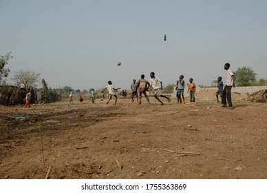 JUBA, SOUTH SUDAN - FEBRUARY 26 2012: Unidentified kids from displaced persons camp play on street, Juba, South Sudan. They often have to find activities for themselves, instead of studying at school.