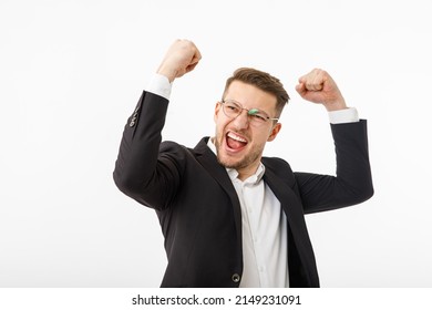 A jubilant businessman white background. A man in a business suit rejoices at success