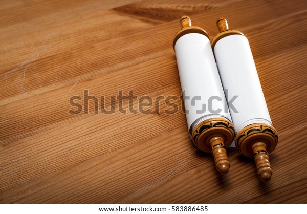 Judaism and religious text concept with a\
closed Torah on wooden background with copy\
space