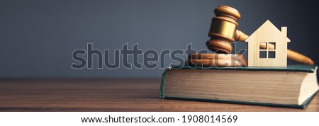 Judge auction and real estate concept. House model, gavel and law books 