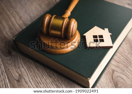Judge auction and real estate concept. House model, gavel and law books