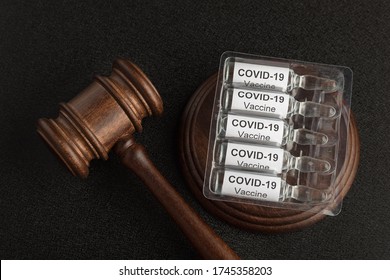 Judge Gavel And Ampoules With Letters Covid19. Laws Against Coronavirus Covid-19.