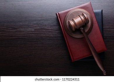 Judge gavel with books on wooden table