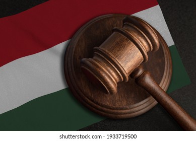 Judge gavel and flag of Hungary. Law and justice in Hungary. Violation of rights and freedoms.