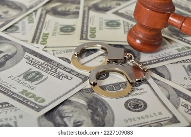 Judge gavel, handcuffs and money banknotes. Economic crime, scam, bail and corruption concept. - Shutterstock ID 2227109083