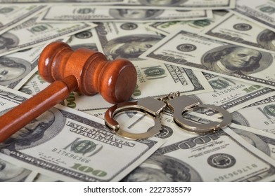 Judge gavel, handcuffs and money banknotes. Economic crime, scam, bail and corruption concept. - Shutterstock ID 2227335579