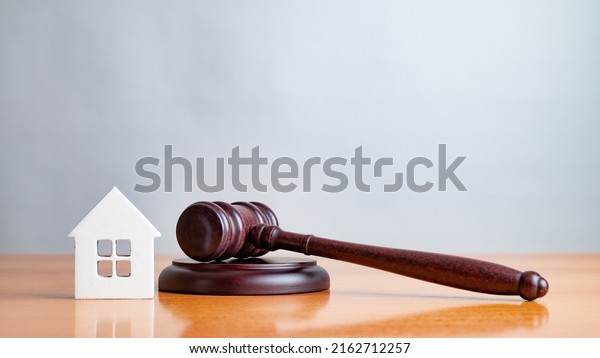 Judge gavel and house. Concept of real estate\
auction or dividing house when divorce, division of property, real\
estate, law system