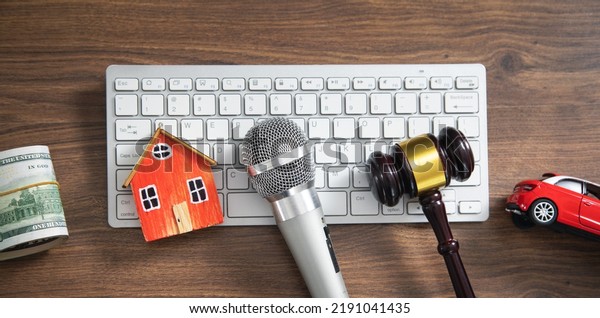 Judge gavel, house, money, car, microphone,\
computer keyboard. Concept of\
Auction