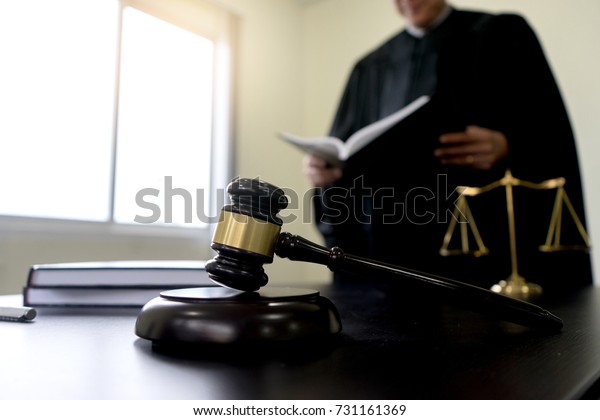 Judge gavel with\
Justice lawyer Plaintiff or defendant  meeting at law firm in\
background. Concept of Law\
firm
