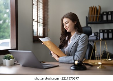 Judge gavel with Justice lawyers, Business woam in suit or lawyer working on laptop and documents. Legal law, advice and justice concept. - Shutterstock ID 2217570897