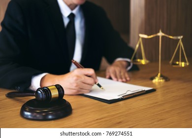 Judge gavel with Justice lawyers, Businessman in suit or lawyer working on a documents. Legal law, advice and justice concept.