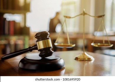 Judge gavel with Justice  lawyers having team meeting at law firm in background. Concepts of law. - Shutterstock ID 1081695920