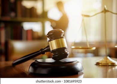 Judge gavel with Justice  lawyers having team meeting at law firm in background. Concepts of law. - Shutterstock ID 1081695923